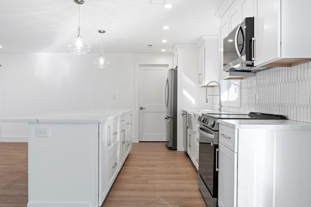 27 Trinity Street Danvers, MA 01923 - Photo 6 of 27 a kitchen with stainless steel appliances granite countertop a refrigerator a stove and a sink