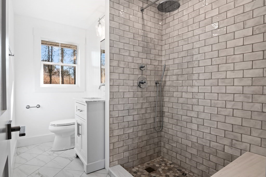 27 Trinity Street Danvers, MA 01923 - Photo 8 of 27 a bathroom with a toilet and a shower