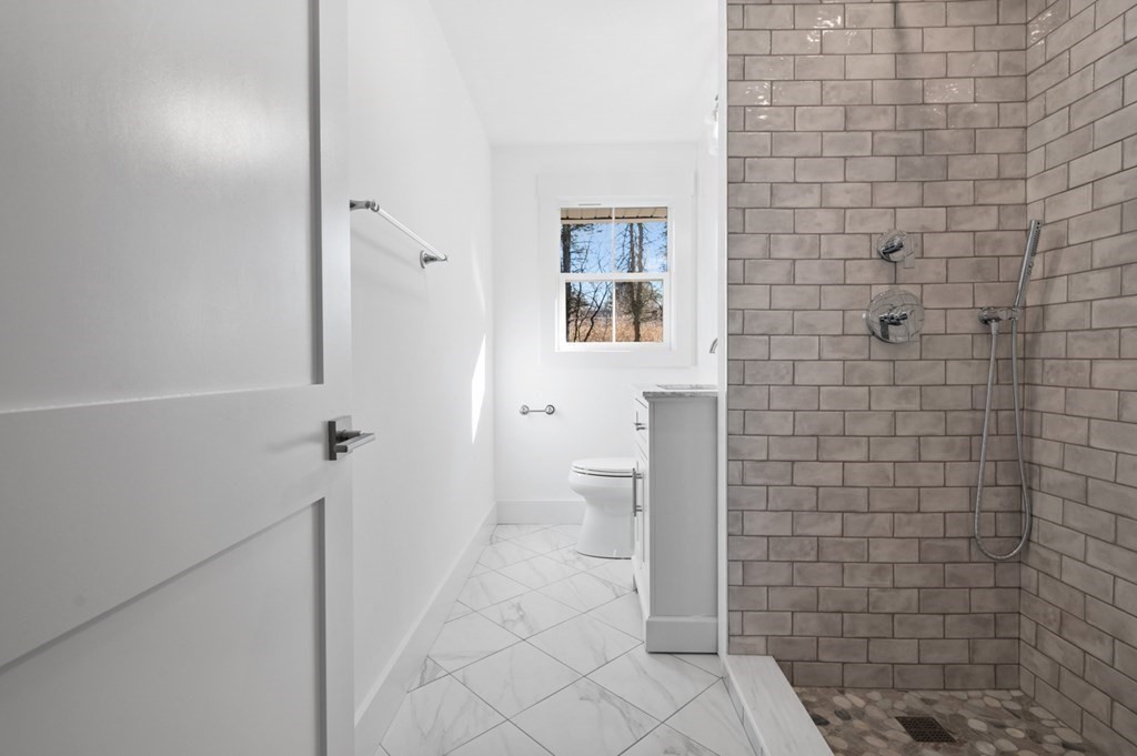 27 Trinity Street Danvers, MA 01923 - Photo 9 of 27 a bathroom with a toilet and a shower