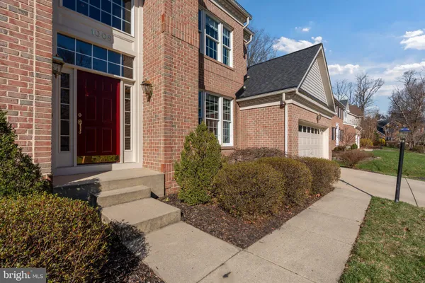 a dining hall with stainless steel appliances granite countertop a stove a sink a dining table and chairs with wooden floor