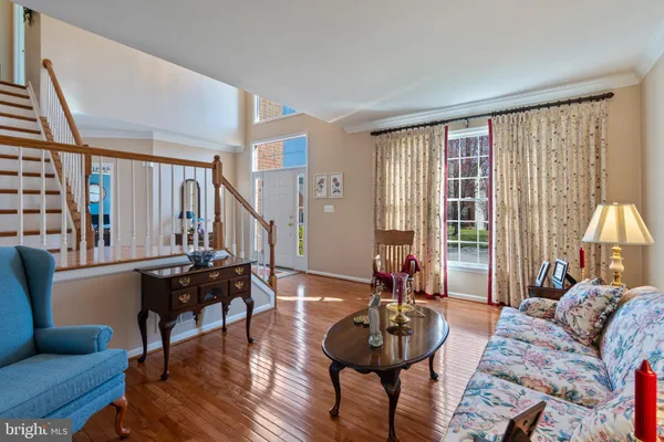a living room with furniture a fireplace and a large window