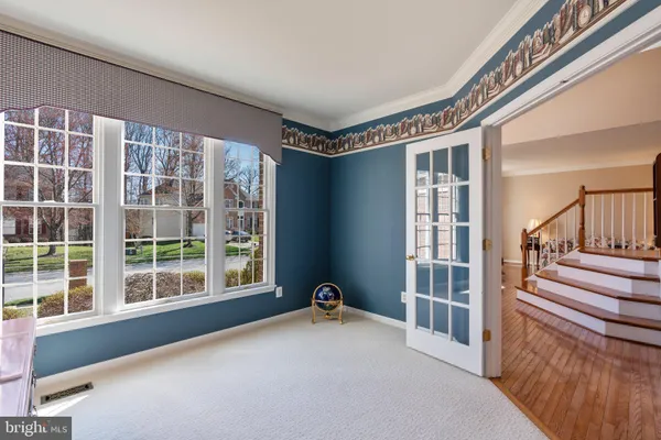 a living room with furniture kitchen view and a wooden floor