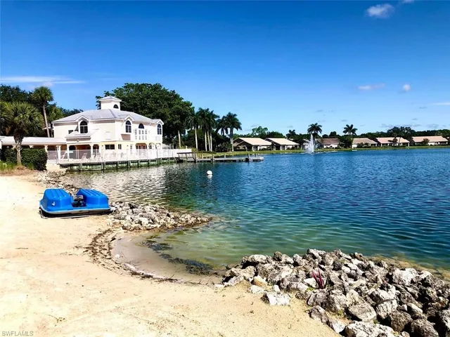 a view of a lake with boats and trees in the background