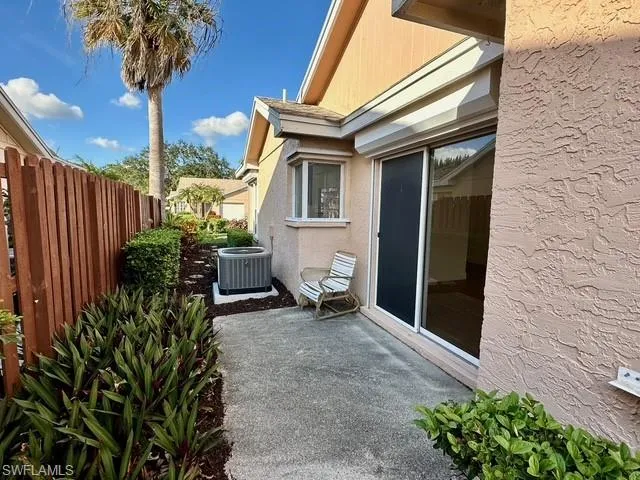 a backyard of a house with table and chairs