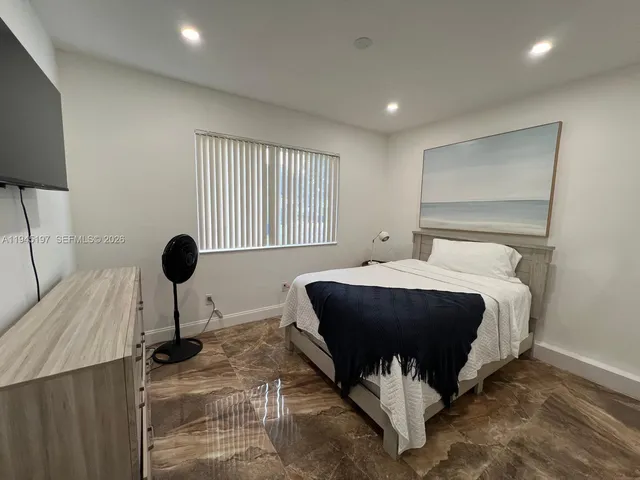 a view of a livingroom with furniture and a flat screen tv