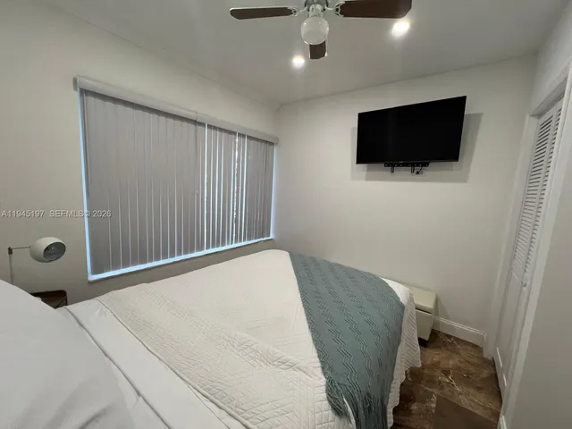 a bedroom with a bed and a couch