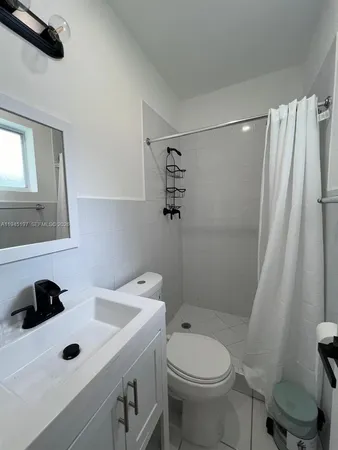 a view of a park with a bench and trees