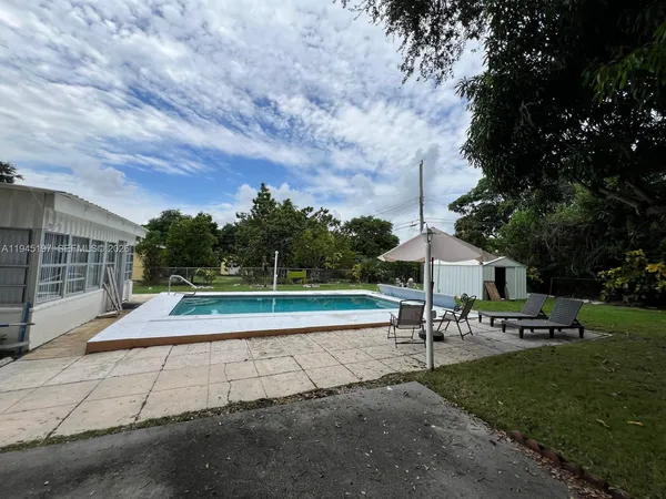 a view of a swimming pool with a lounge chair