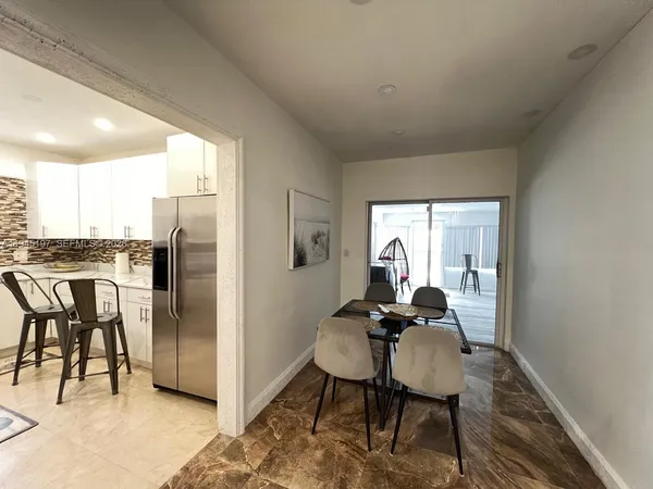 a kitchen with a sink a counter top space cabinets and stainless steel appliances