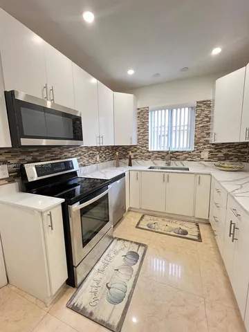 a view of a livingroom with furniture and wooden floor