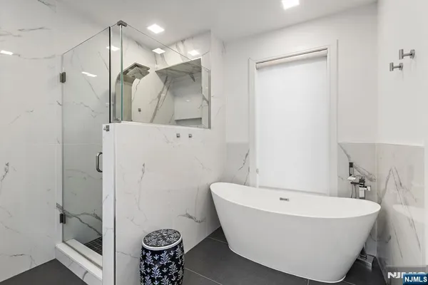 a bathroom with a bathtub and shower