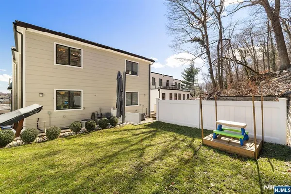 a backyard of a house with table and chairs