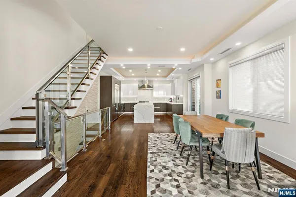 a dining room with furniture entryway and wooden floor
