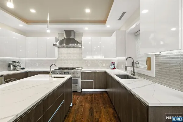 a kitchen with a sink a stove and cabinets