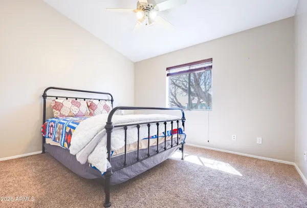 a bedroom with a bed table and a window