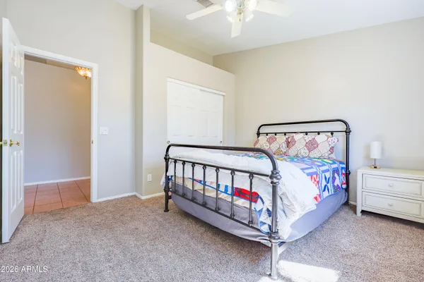 a bedroom with a bed and a chandelier
