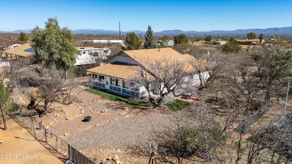 an aerial view of residential houses with outdoor space and trees