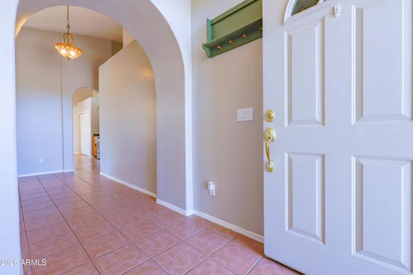 an empty room with closet and a chandelier fan