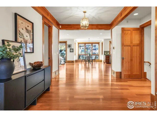 a view of a dining room with furniture large windows and wooden floor
