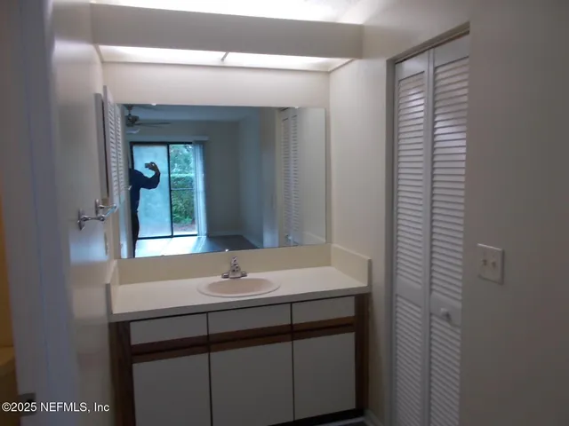 a bathroom with a sink a vanity and a mirror