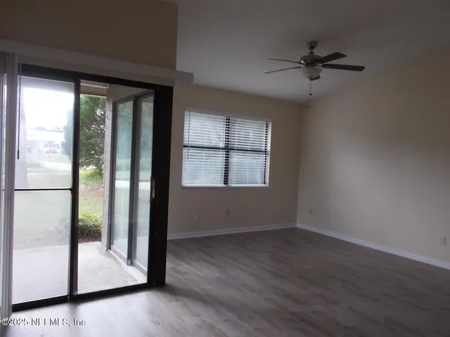 a view of room with window and hardwood floor