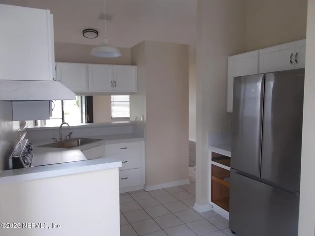 a kitchen with a refrigerator sink and stove