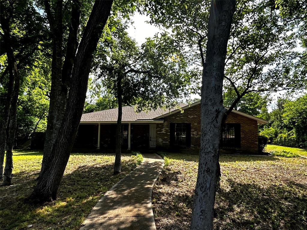 a view of a house with a large tree