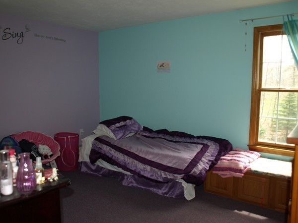 9 A Vinton Road Charlton, MA 01507 - Photo 13 of 23 a bed sitting in a bedroom next to a window
