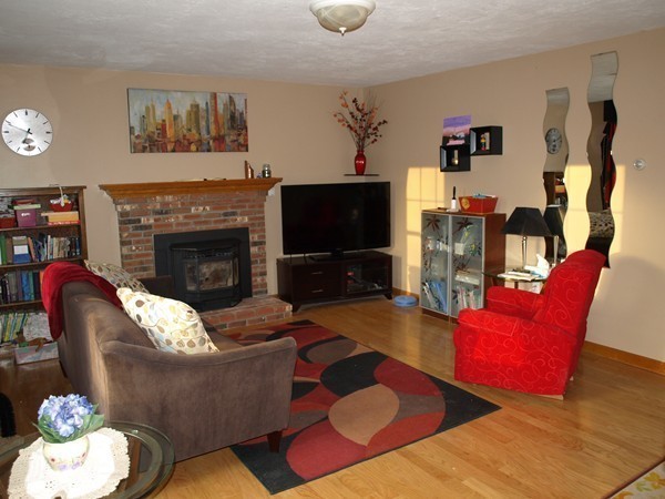 9 A Vinton Road Charlton, MA 01507 - Photo 5 of 23 a living room with furniture a flat screen tv and a fireplace