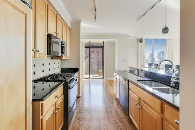 a kitchen with stainless steel appliances granite countertop a stove and a sink