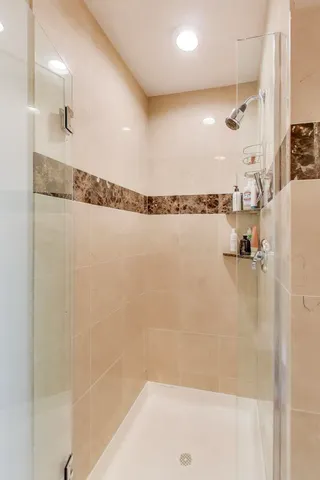 a bathroom with a shower and a bath tub