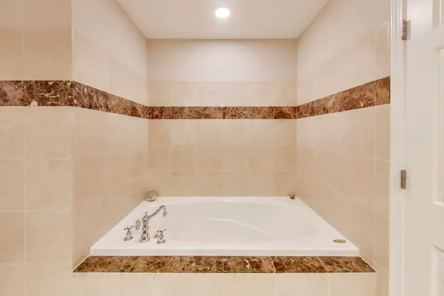 a bathroom with a bath tub and shower