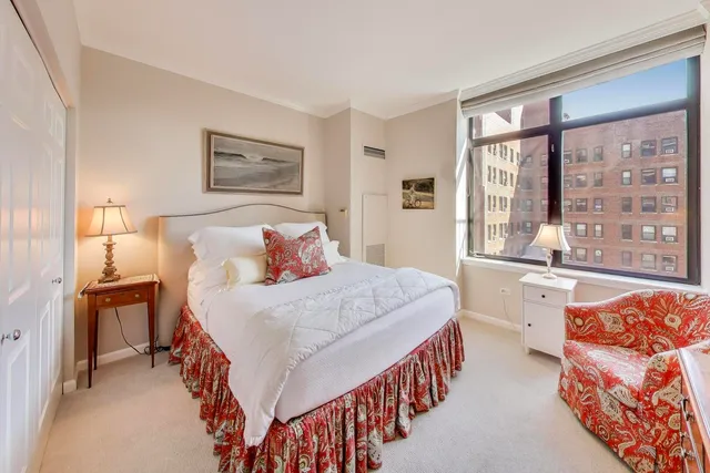 a bedroom with a bed and a large window