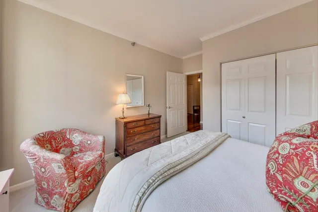 a bedroom with bed and cabinets