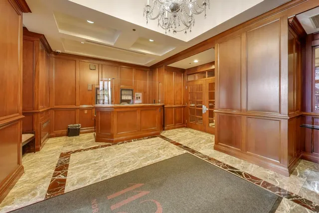 a view of a kitchen with a refrigerator window and wooden cabinets