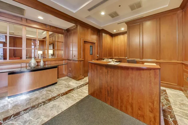 a view of a kitchen with stainless steel appliances granite countertop wooden cabinets and a granite counter tops