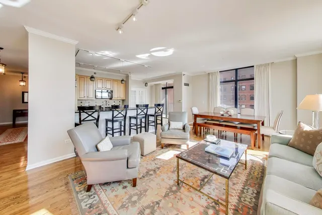 a living room with furniture and kitchen view