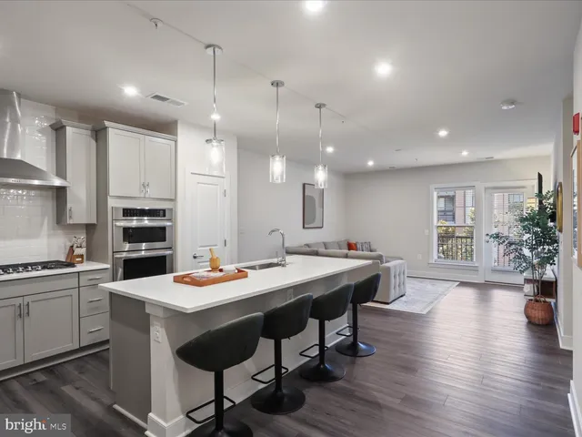 a large kitchen with a table and chairs