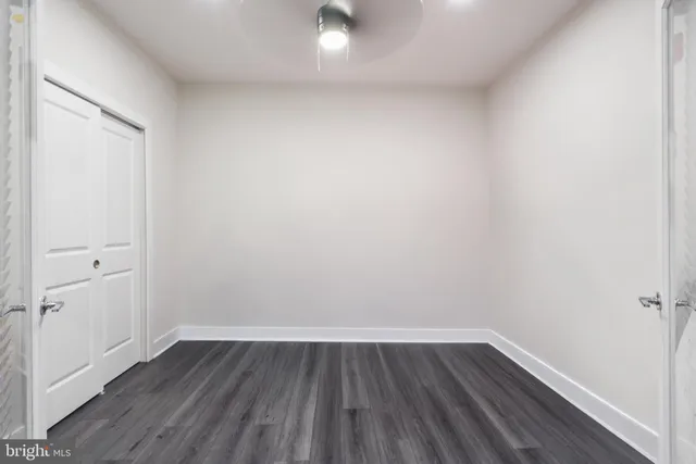 a view of a small space with wooden floor and a window
