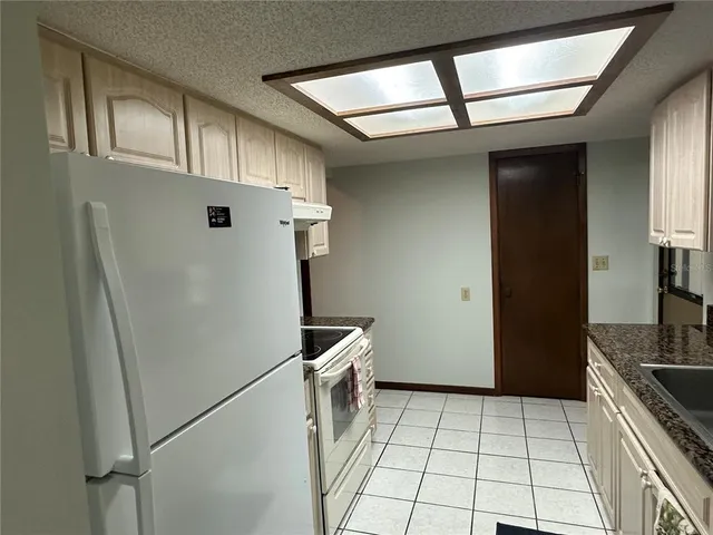 a kitchen with a refrigerator and cabinets