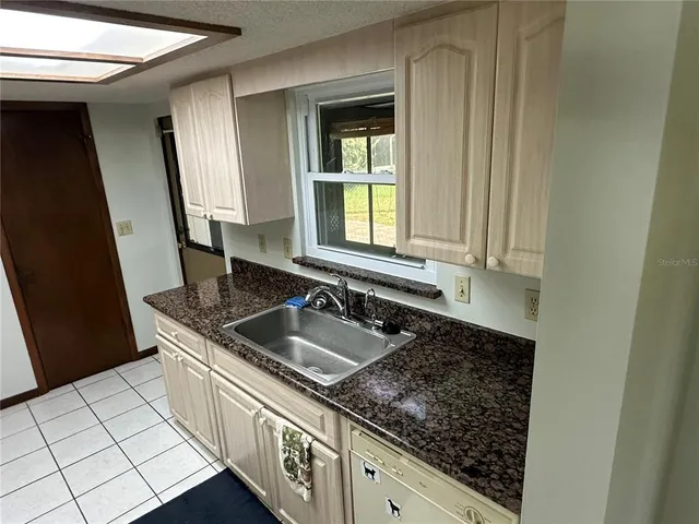 a kitchen with sink and window