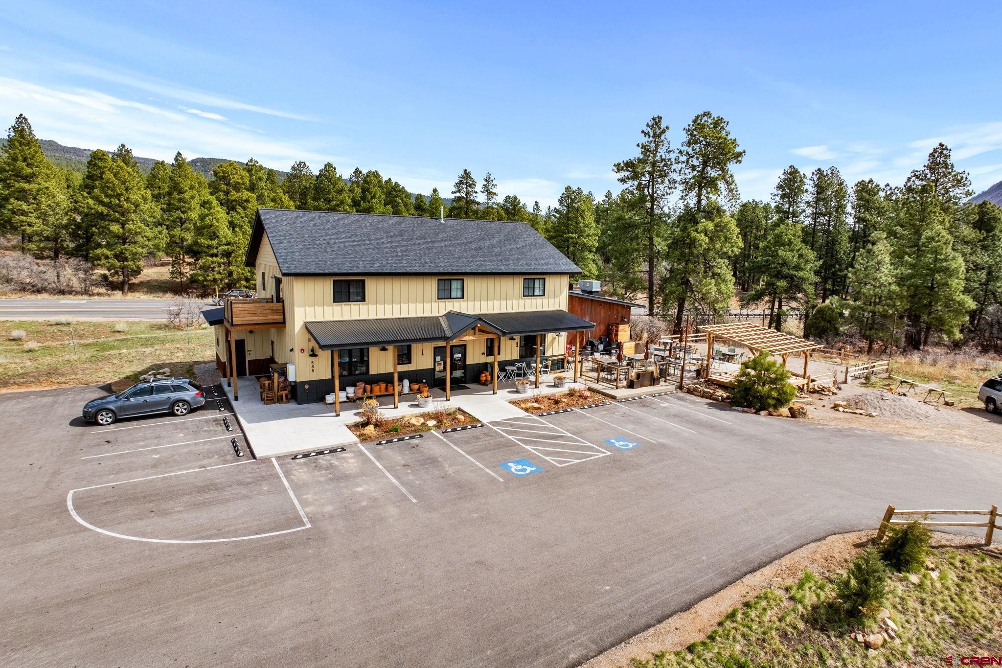 671 Edgemont Meadows Road Durango, CO 81301 - Photo 8 of 15 a view of a patio with a table and chairs under an umbrella
