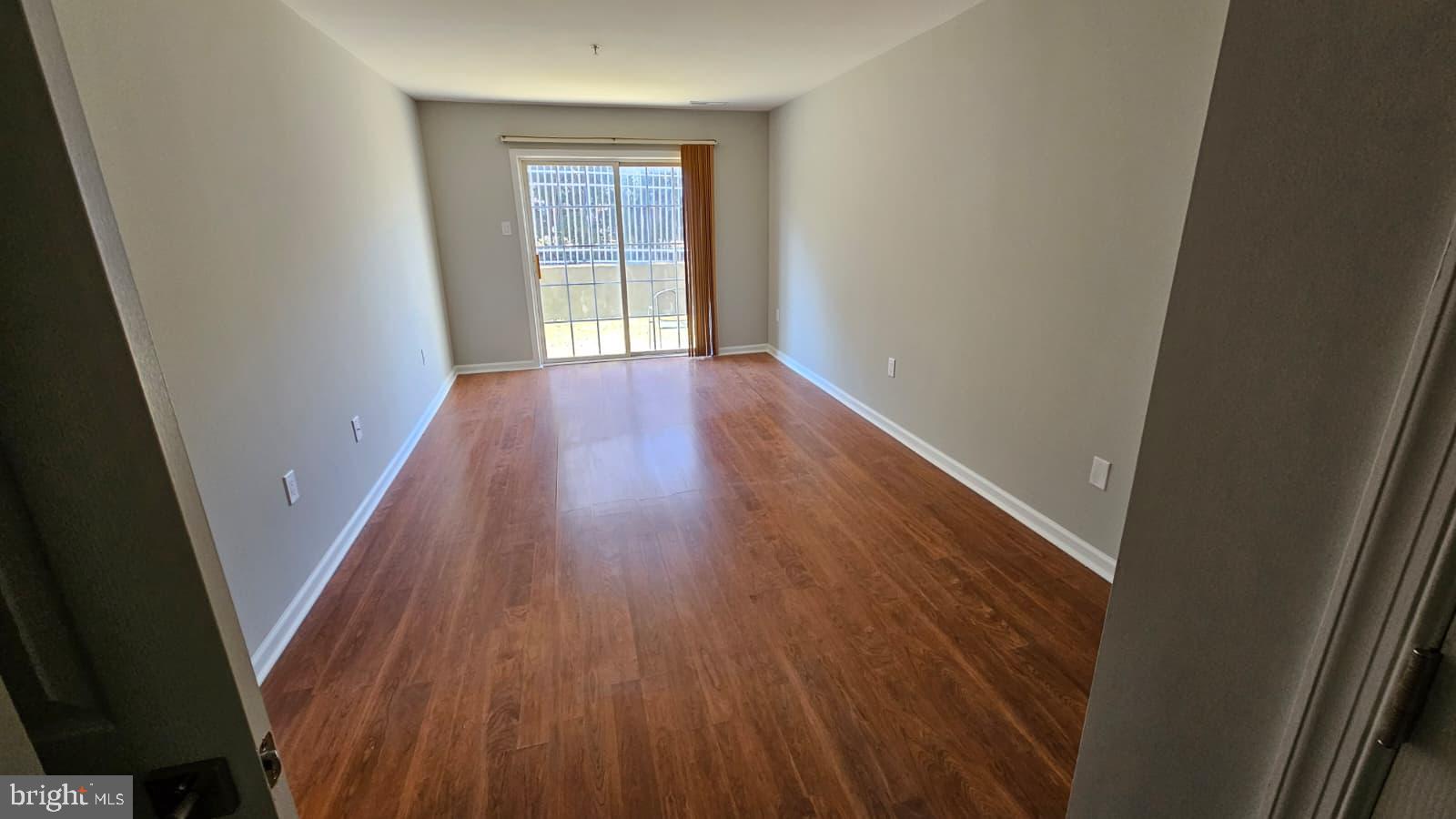 9228-38 Blue Grass Road, Unit 27 Philadelphia, PA 19114 - Photo 12 of 15 wooden floor in an empty room with a window