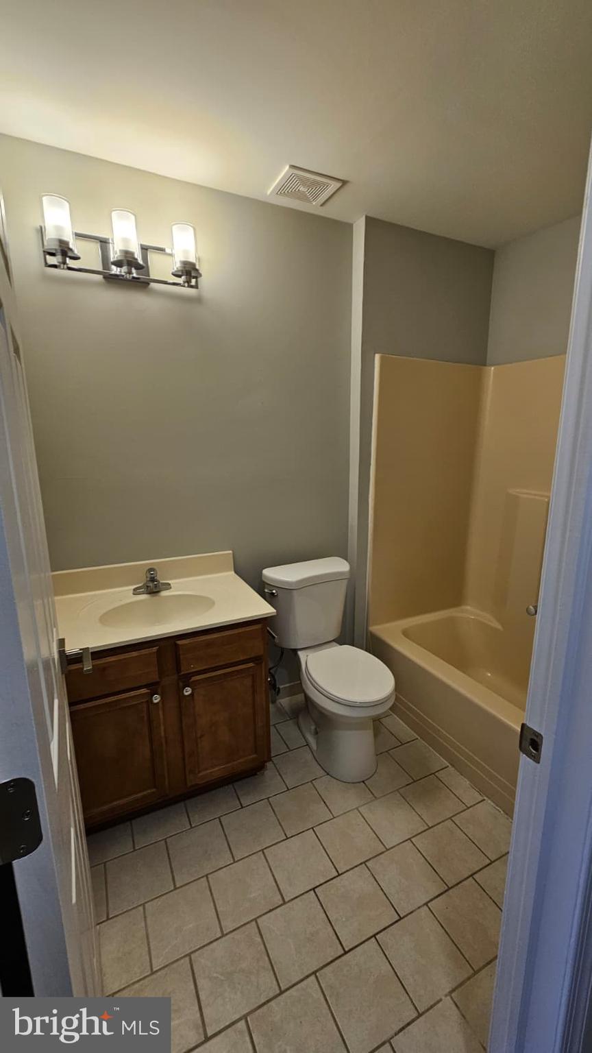 9228-38 Blue Grass Road, Unit 27 Philadelphia, PA 19114 - Photo 14 of 15 a bathroom with a sink a toilet and shower