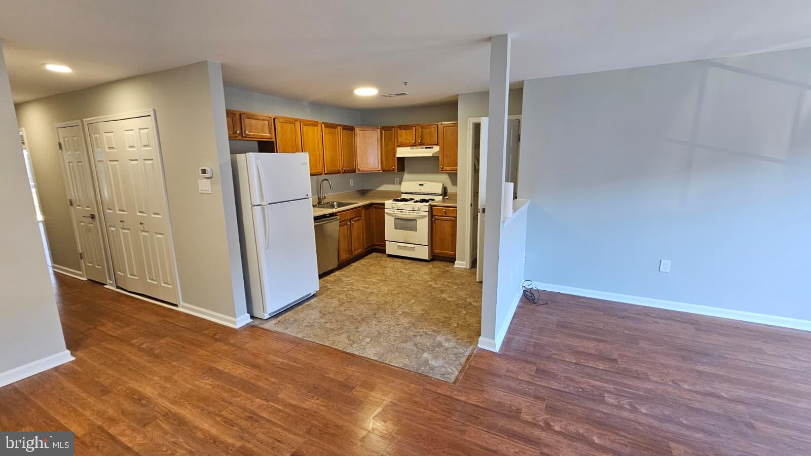 9228-38 Blue Grass Road, Unit 27 Philadelphia, PA 19114 - Photo 2 of 15 a kitchen with stainless steel appliances a refrigerator and a stove top oven