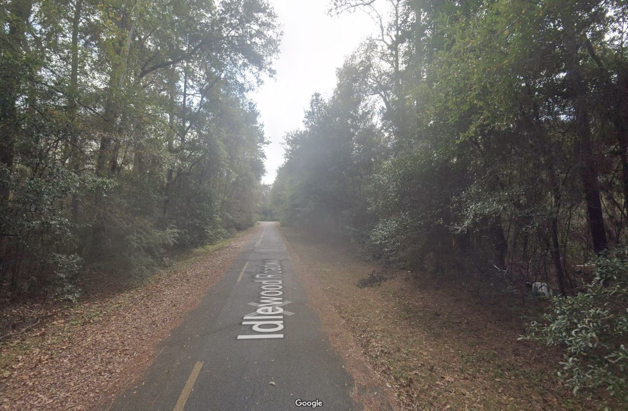 a view of a street with trees in the background