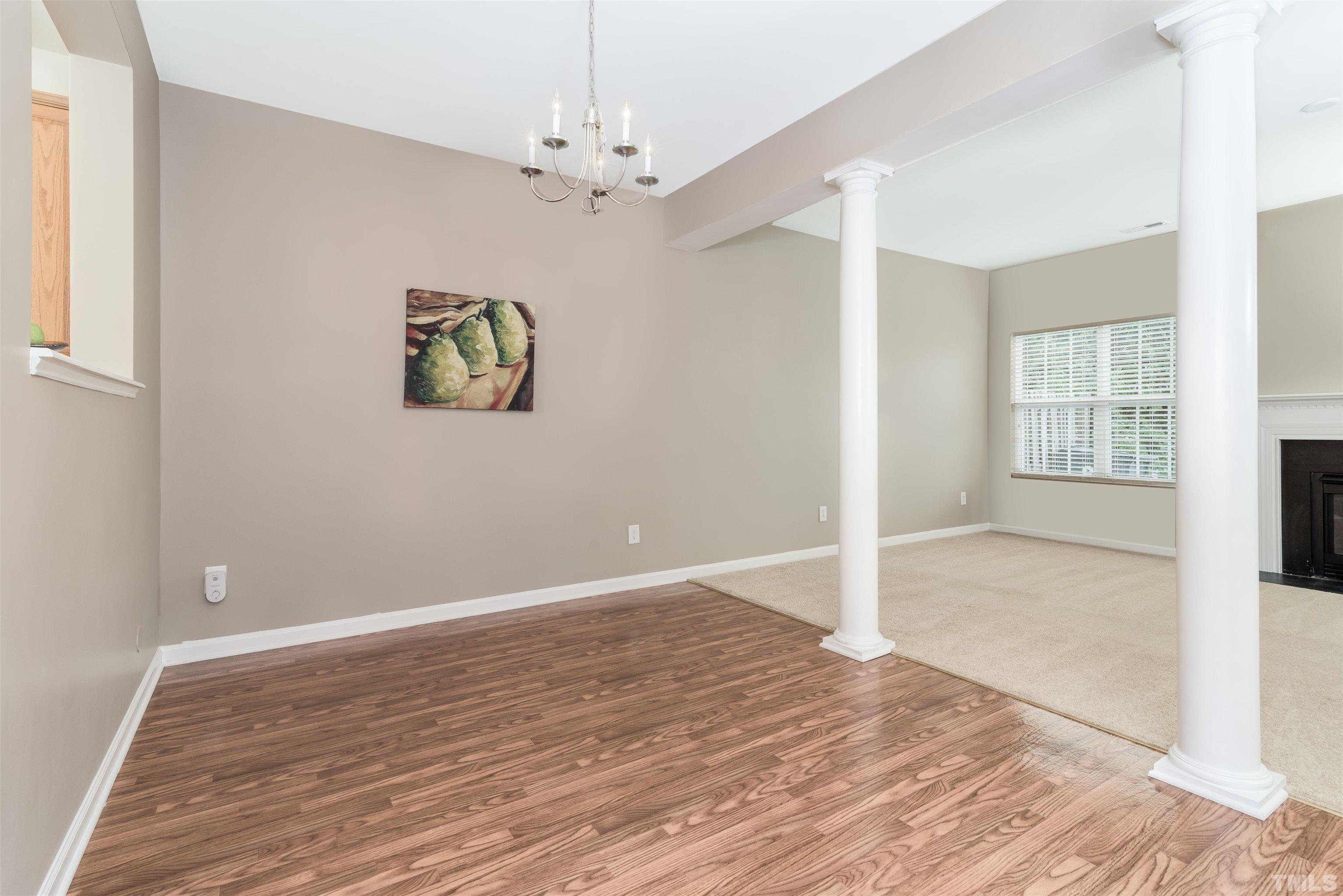105 Graystar Road Apex, NC 27502 - Photo 12 of 35 a view of an empty room with wooden floor and a window