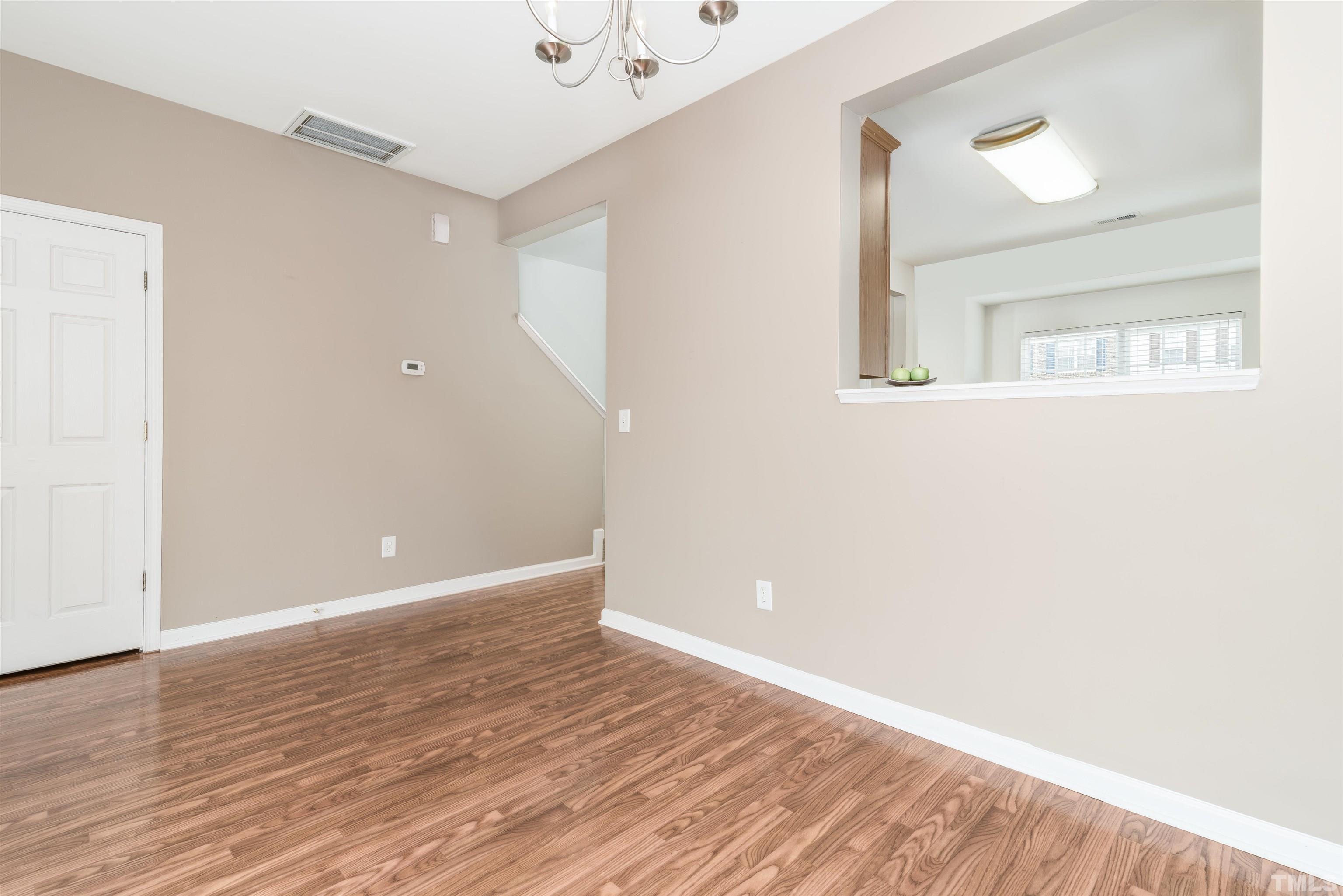 105 Graystar Road Apex, NC 27502 - Photo 14 of 35 a view of an empty room with wooden floor