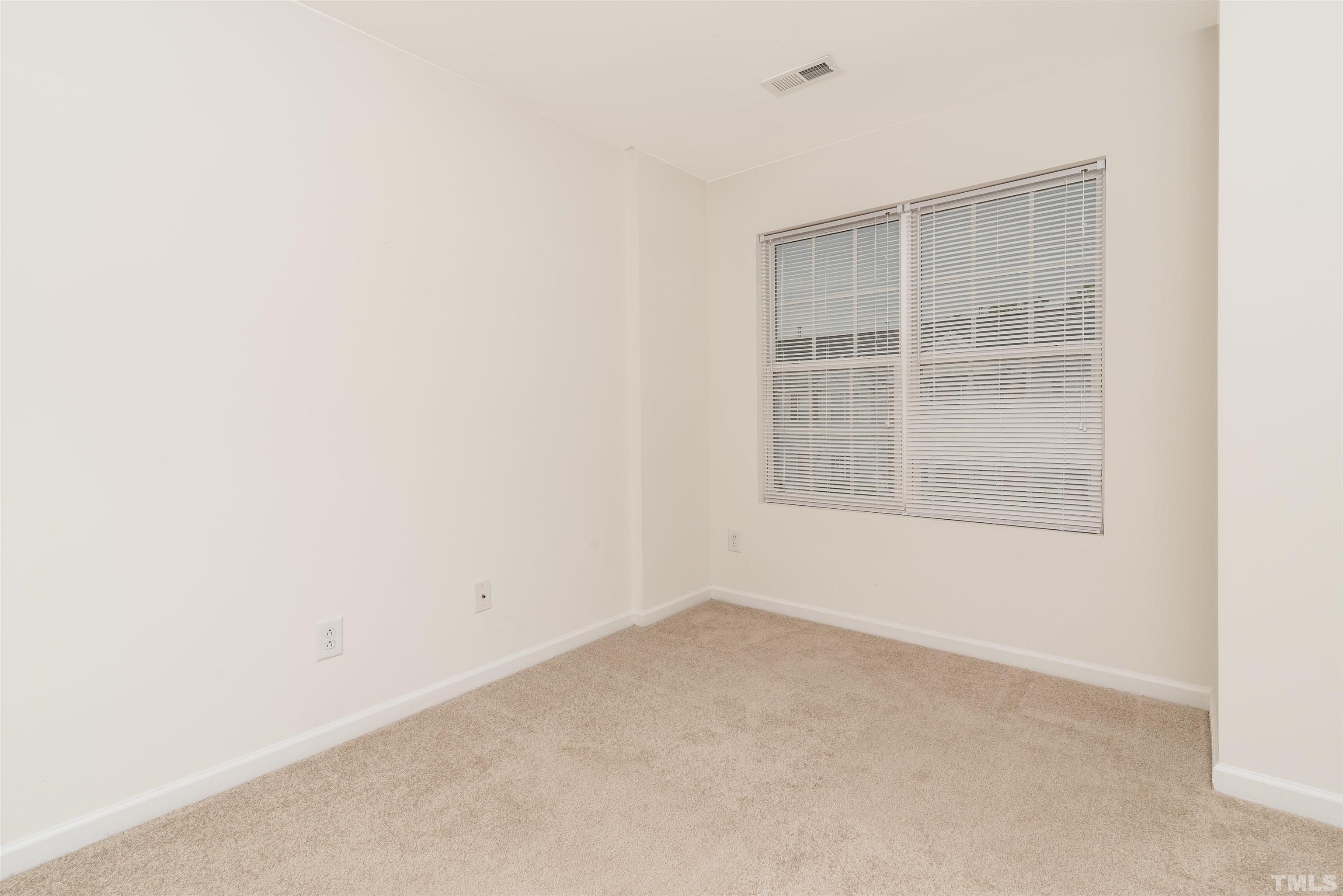 105 Graystar Road Apex, NC 27502 - Photo 19 of 35 a view of an empty room with a window