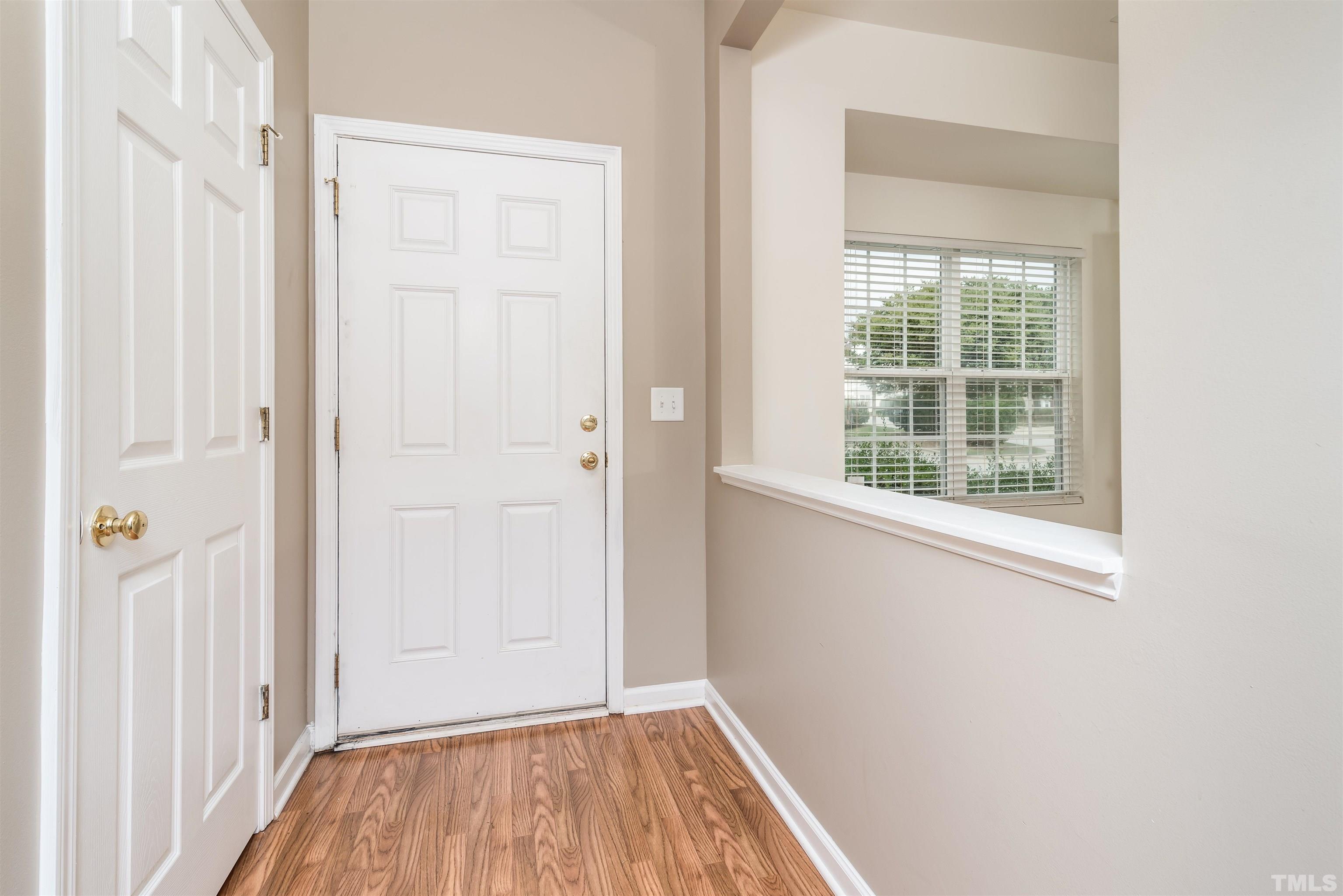 105 Graystar Road Apex, NC 27502 - Photo 2 of 35 an empty room with wooden floor and a window